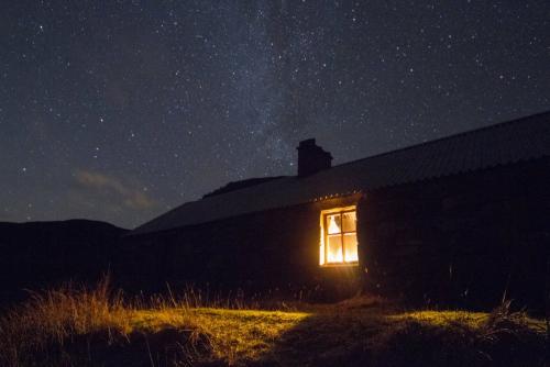 Bothy by night with Milky Way overhead, Highlands, Scotland